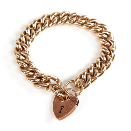 1205 - An unmarked gold hollow curb link bracelet, with 9ct heart padlock clasp, hallmarks London 1995, bra... 