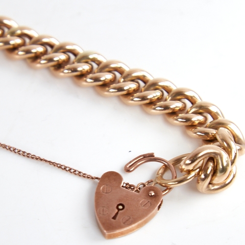 1205 - An unmarked gold hollow curb link bracelet, with 9ct heart padlock clasp, hallmarks London 1995, bra... 