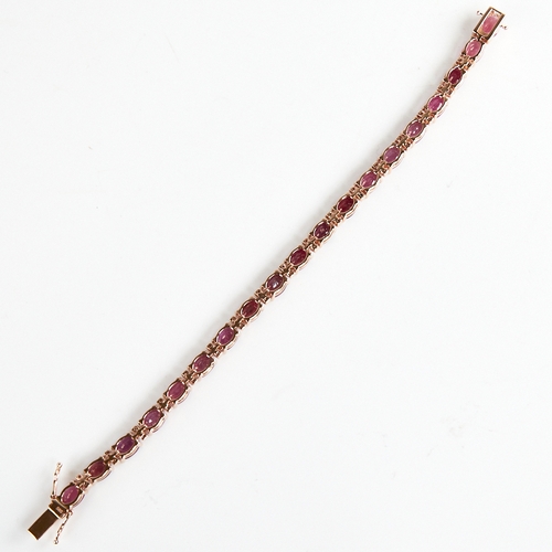 1210 - A modern 14ct rose gold ruby and diamond line bracelet, set with oval-cut rubies with double round b... 