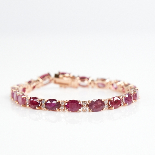 1210 - A modern 14ct rose gold ruby and diamond line bracelet, set with oval-cut rubies with double round b... 