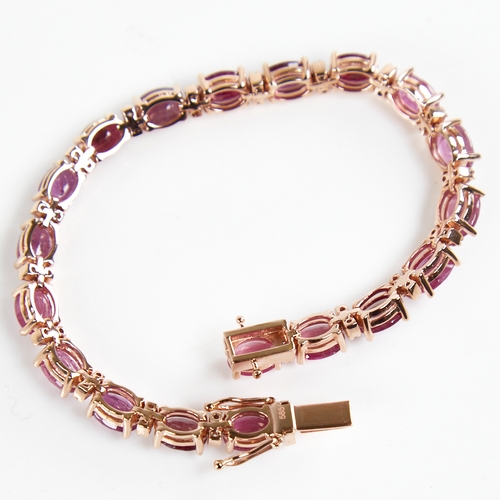 1210 - A modern 14ct rose gold ruby and diamond line bracelet, set with oval-cut rubies with double round b... 