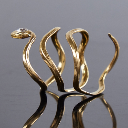 1211 - An unmarked gold diamond figural snake/serpent ring, the head set with an oval old-cut diamond, diam... 