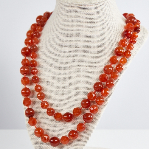 1212 - A long Vintage graduated faceted and polished carnelian bead necklace, alternating bead styles, larg... 