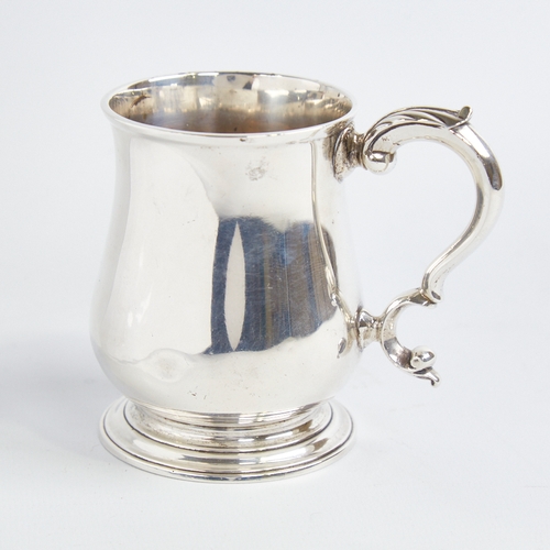 1215 - A George III silver christening tankard mug, baluster form with scrolled acanthus leaf handle, indis... 