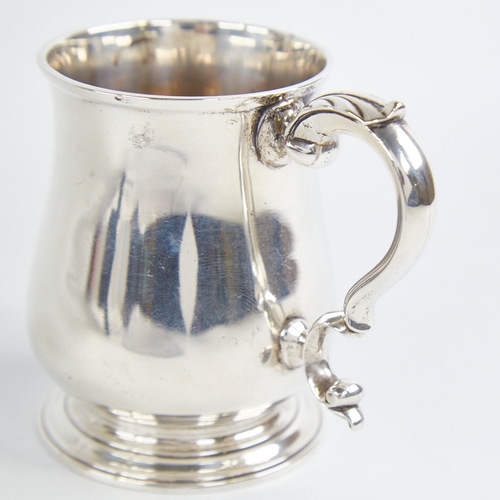 1215 - A George III silver christening tankard mug, baluster form with scrolled acanthus leaf handle, indis... 