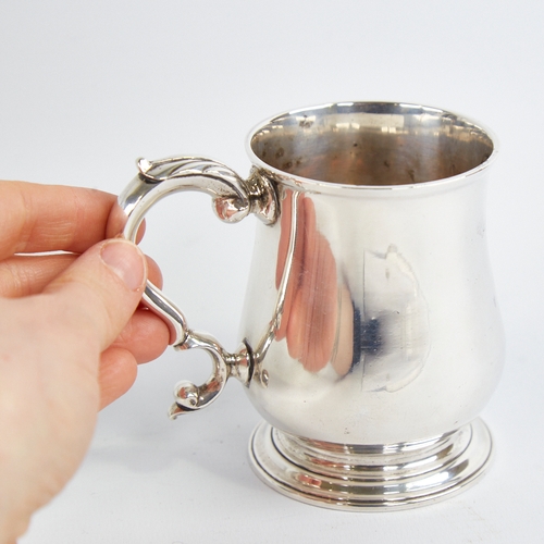 1215 - A George III silver christening tankard mug, baluster form with scrolled acanthus leaf handle, indis... 