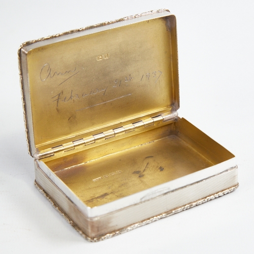 1217 - A George V silver snuffbox, plain rectangular form with cast floral border and allover engine turned... 