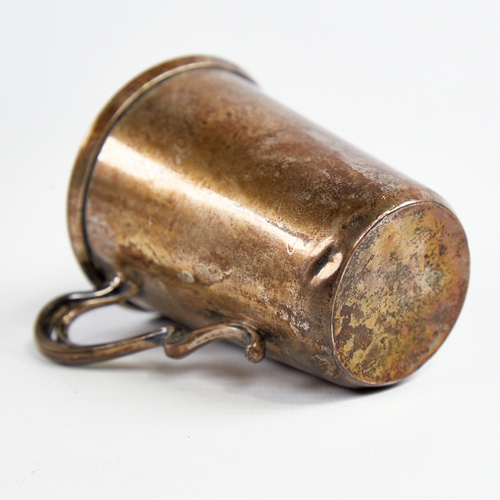 1219 - A small Art Nouveau German silver mug, relief embossed floral decoration with natural formed handle,... 