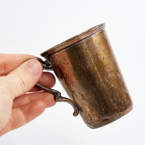 1219 - A small Art Nouveau German silver mug, relief embossed floral decoration with natural formed handle,... 