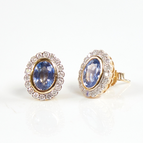 1223 - A modern pair of 14ct gold sapphire and diamond cluster stud earrings, set with oval-cut sapphires s... 