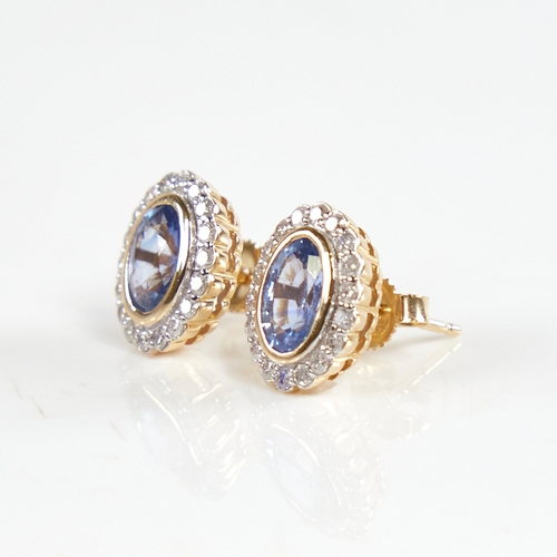 1223 - A modern pair of 14ct gold sapphire and diamond cluster stud earrings, set with oval-cut sapphires s... 