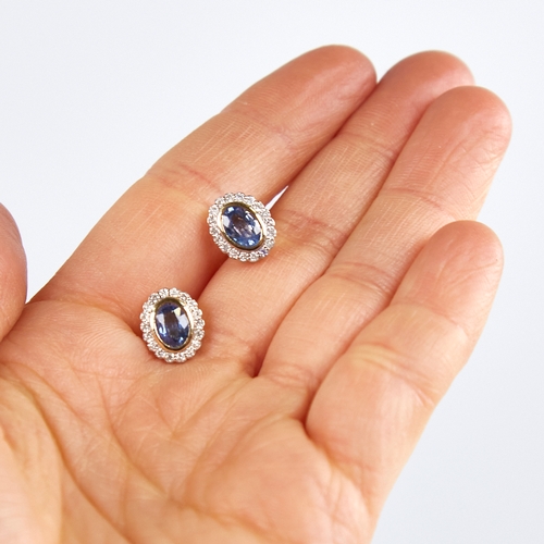 1223 - A modern pair of 14ct gold sapphire and diamond cluster stud earrings, set with oval-cut sapphires s... 