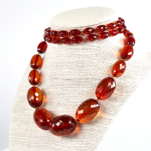 1225 - A Vintage graduate single-row faceted amber bead necklace, beads measuring from 29.8mm to 11.5mm, ne... 