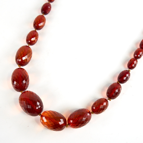 1225 - A Vintage graduate single-row faceted amber bead necklace, beads measuring from 29.8mm to 11.5mm, ne... 