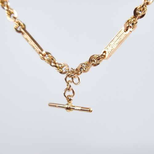 1227 - An early/mid-20th century 9ct gold fancy link double Albert chain necklace, with engraved oval bar a... 