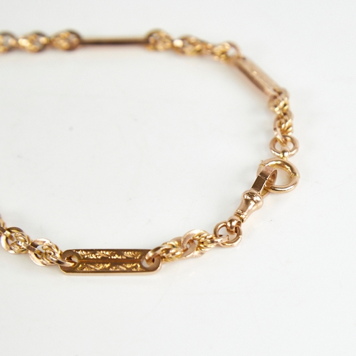 1227 - An early/mid-20th century 9ct gold fancy link double Albert chain necklace, with engraved oval bar a... 