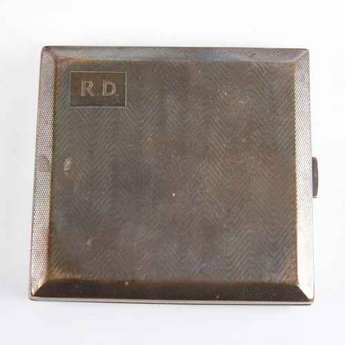 1235 - A George V Art Deco silver cigarette case, square form with wavey engine turned decoration and gilt ... 