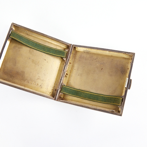 1235 - A George V Art Deco silver cigarette case, square form with wavey engine turned decoration and gilt ... 