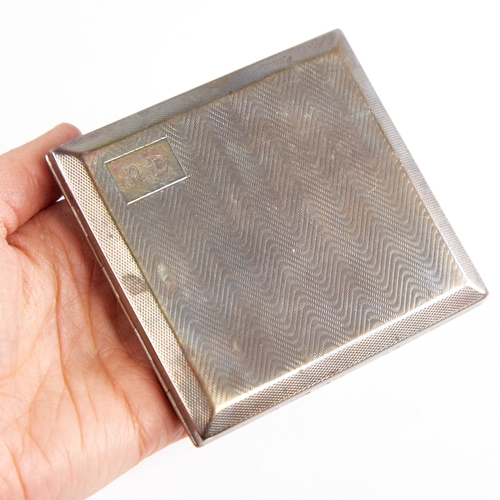 1235 - A George V Art Deco silver cigarette case, square form with wavey engine turned decoration and gilt ... 