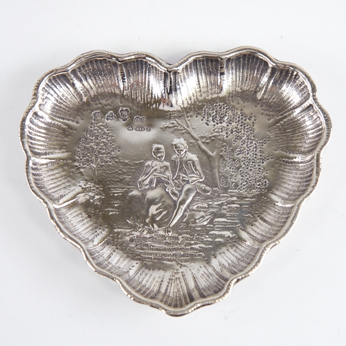 1237 - A late 19th/early 20th century German silver heart-shaped dish, Hanau, relief embossed lover decorat... 