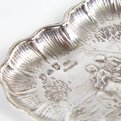 1237 - A late 19th/early 20th century German silver heart-shaped dish, Hanau, relief embossed lover decorat... 