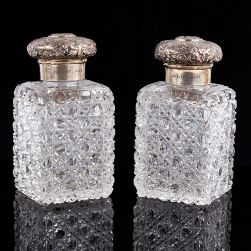 1241 - A pair of Victorian silver-mounted cut-glass hobnail dressing table scent bottle jars, relief emboss... 