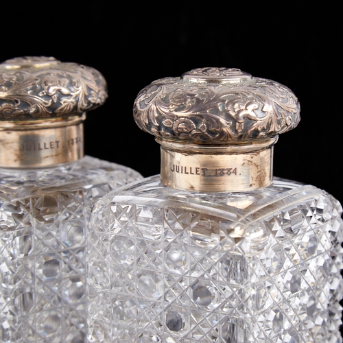 1241 - A pair of Victorian silver-mounted cut-glass hobnail dressing table scent bottle jars, relief emboss... 