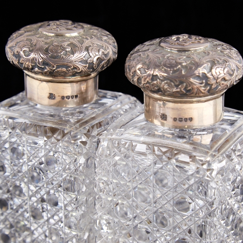 1241 - A pair of Victorian silver-mounted cut-glass hobnail dressing table scent bottle jars, relief emboss... 