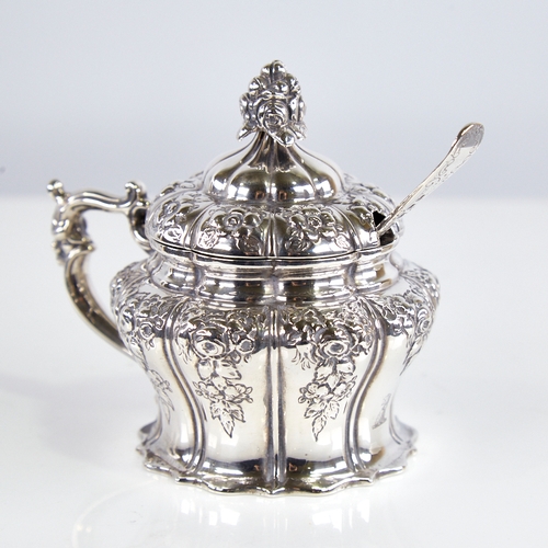 1242 - A Victorian silver mustard pot, pumpkin form with relief embossed floral decoration, floral finial, ... 