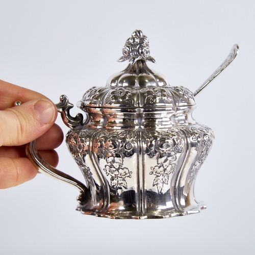 1242 - A Victorian silver mustard pot, pumpkin form with relief embossed floral decoration, floral finial, ... 