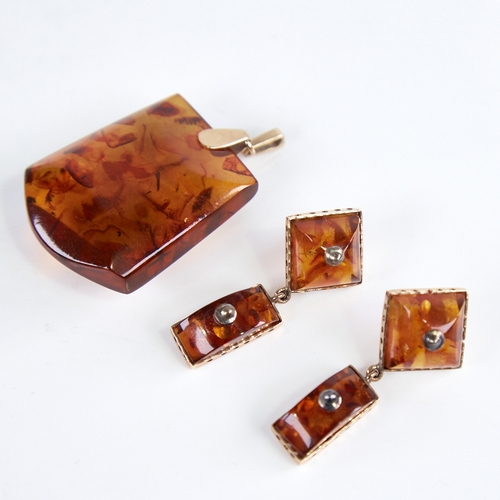 1250 - A Vintage amber demi-parure, comprising unmarked gold-mounted pendant and pair of unmarked gold-moun... 