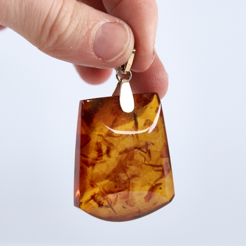 1250 - A Vintage amber demi-parure, comprising unmarked gold-mounted pendant and pair of unmarked gold-moun... 