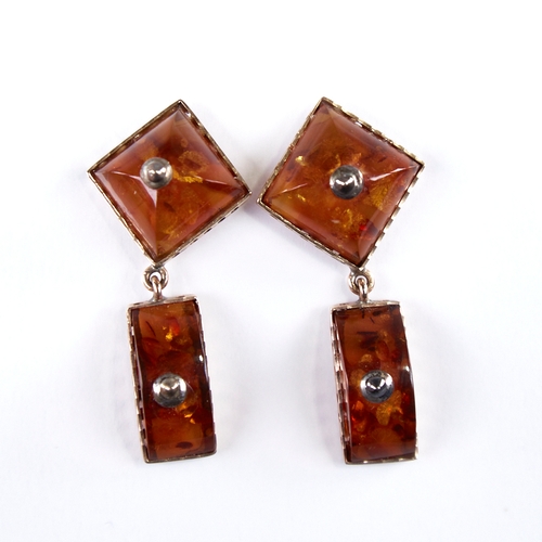 1250 - A Vintage amber demi-parure, comprising unmarked gold-mounted pendant and pair of unmarked gold-moun... 