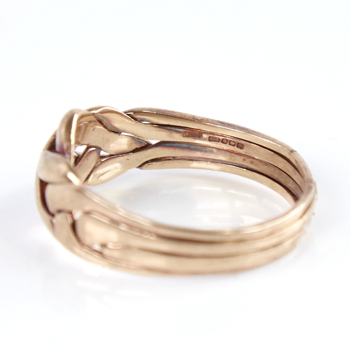 1251 - A modern 9ct gold puzzle knot ring, formed as 4 separate bands intertwined, setting height 10.8mm, s... 