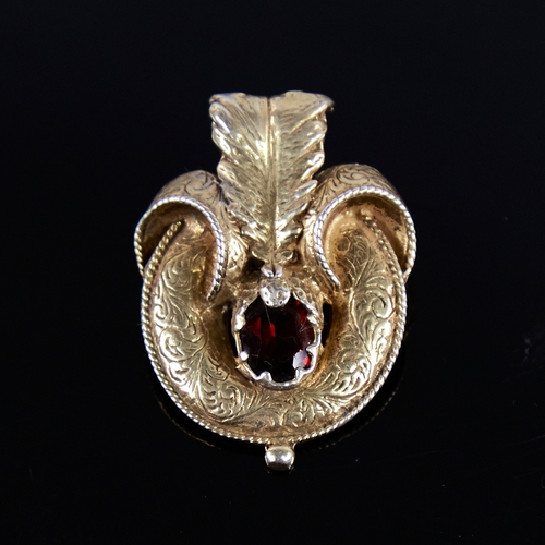 1254 - A Victorian unmarked gold garnet motif brooch, set with oval-cut garnet with allover engraved foliat... 