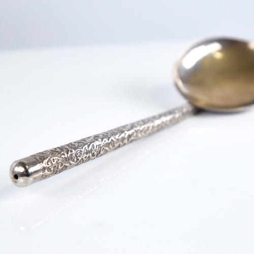 1255 - A large Indian unmarked white metal serving spoon, relief embossed foliate handle, length 26cm, 1.6o... 