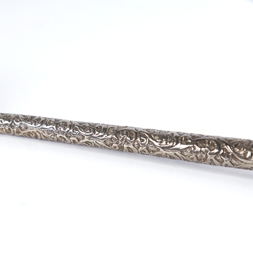 1255 - A large Indian unmarked white metal serving spoon, relief embossed foliate handle, length 26cm, 1.6o... 