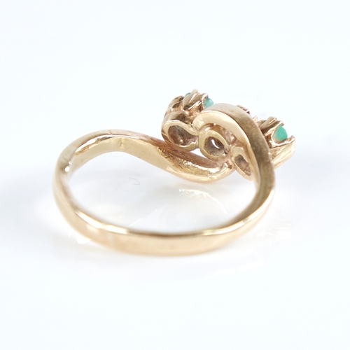 1265 - An early 20th century unmarked high carat gold 3-stone emerald and diamond crossover ring, set with ... 