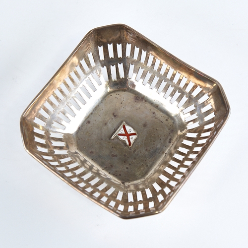 1266 - A small George V silver bon bon dish, canted square form with pierced gallery and central enamelled ... 