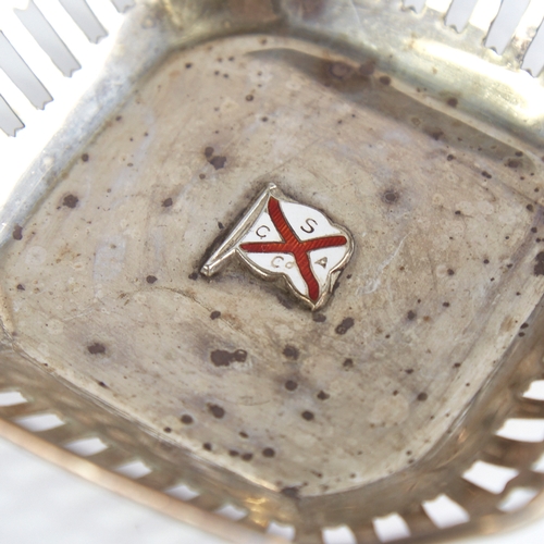 1266 - A small George V silver bon bon dish, canted square form with pierced gallery and central enamelled ... 