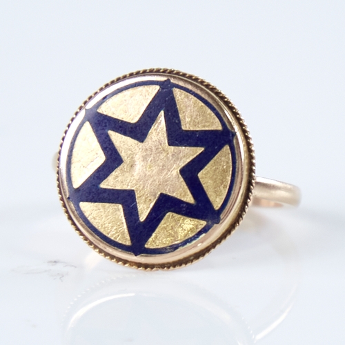 1271 - A 19th century unmarked gold blue enamel star insignia panel ring, within rope twist surround, panel... 