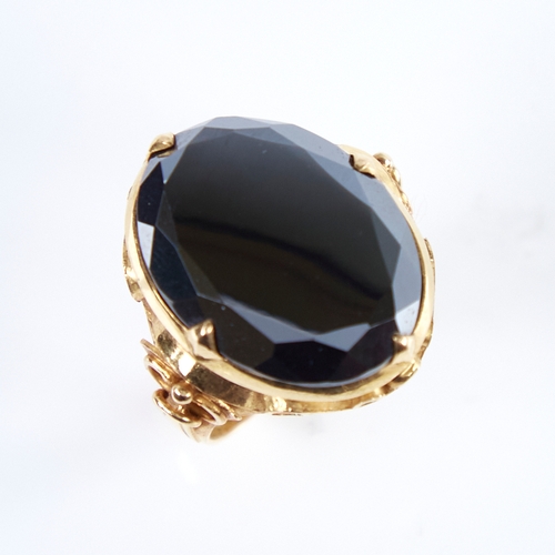 1279 - A late 20th century Chinese high carat gold hematite ring, set with a large oval-cut hematite with o... 