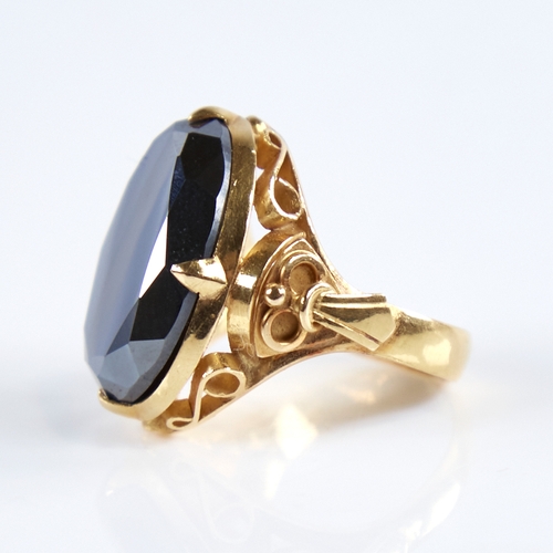 1279 - A late 20th century Chinese high carat gold hematite ring, set with a large oval-cut hematite with o... 