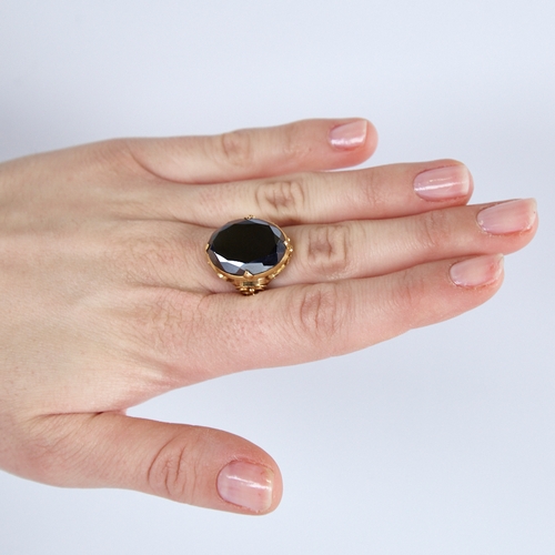 1279 - A late 20th century Chinese high carat gold hematite ring, set with a large oval-cut hematite with o... 