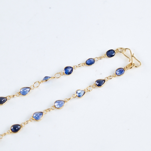 1287 - A modern handmade unmarked high carat gold sapphire line necklace, set with oval and pear-cut sapphi... 