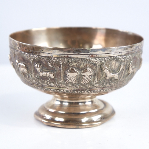 1298 - An early 20th century unmarked Indian silver pedestal bowl, relief embossed animal decoration, diame... 