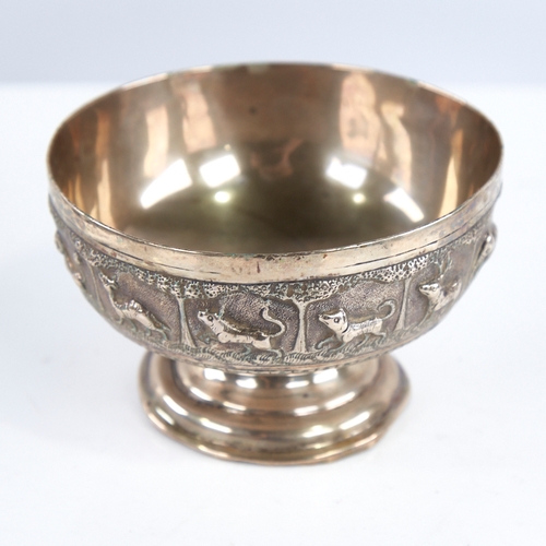 1298 - An early 20th century unmarked Indian silver pedestal bowl, relief embossed animal decoration, diame... 