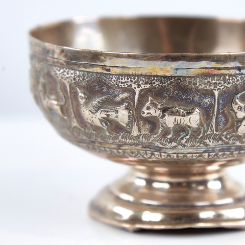 1298 - An early 20th century unmarked Indian silver pedestal bowl, relief embossed animal decoration, diame... 