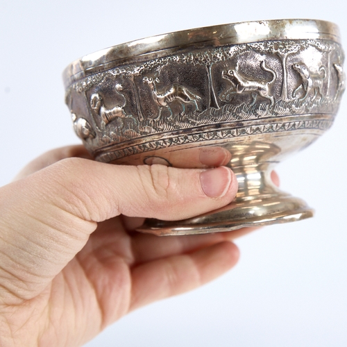 1298 - An early 20th century unmarked Indian silver pedestal bowl, relief embossed animal decoration, diame... 