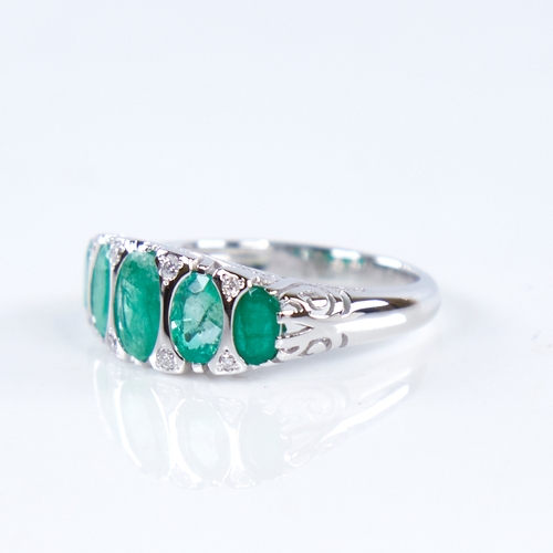 1307 - A modern 14ct white gold graduate 5-stone emerald and diamond half hoop ring, set with oval-cut emer... 